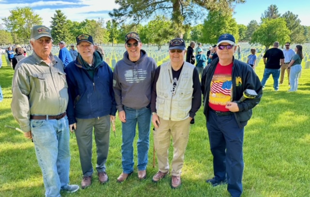 Many Volunteers placed Flags for fallen vets at Ft Logan Cemetery 2024